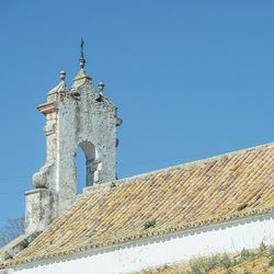 Low angle view of built structure against clear blue sky