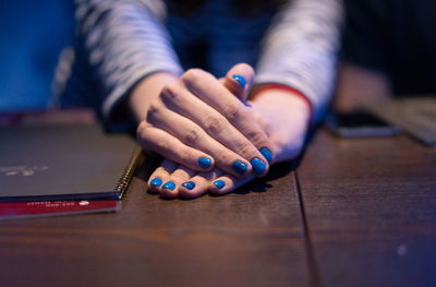 Midsection of woman sitting at table