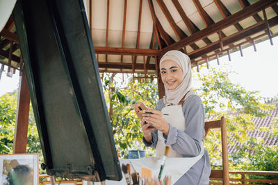 Portrait of young woman using phone