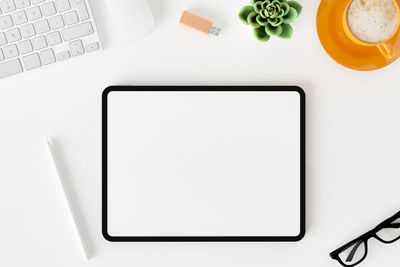 Directly above view of white and laptop on table