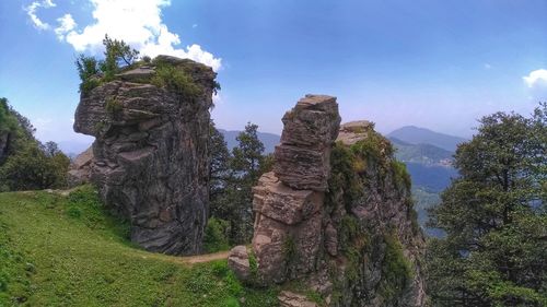 Rock formations on landscape against sky