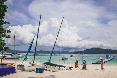 People on beach against sky