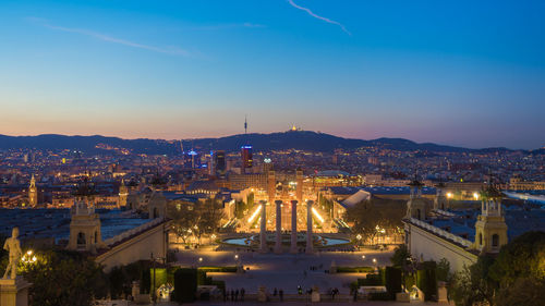 High angle view of city lit up at night