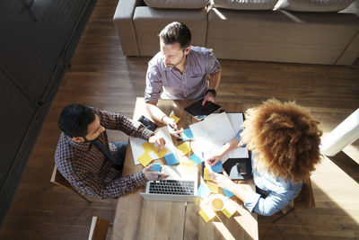 High angle view of colleagues working at table in office