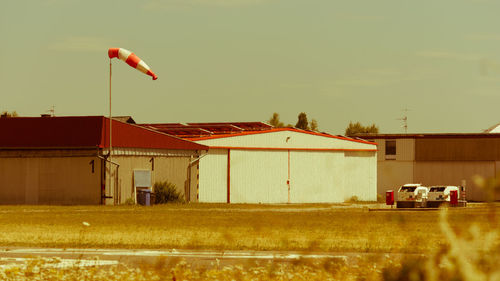 Houses on field against sky