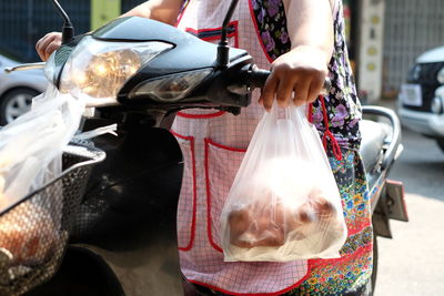 Midsection of woman riding motorcycle