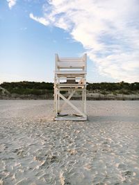 Lifeguard hut on beach against sky