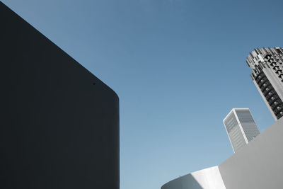 Low angle view of buildings against clear blue sky