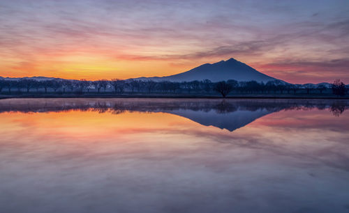 Scenic view of lake against romantic sky at sunset