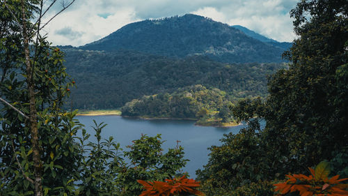 Scenic view of lake and mountains against sky