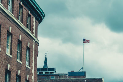 Low angle view of building against cloudy sky