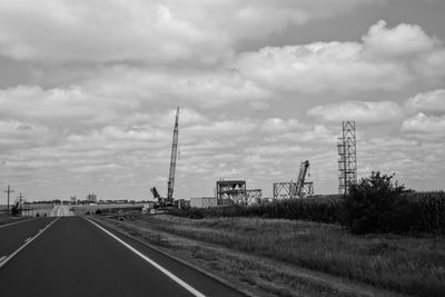 Road by plants against sky