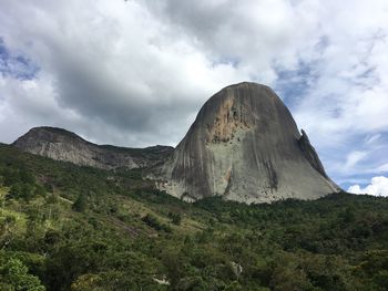 Low angle view of mountain against cloudy sky