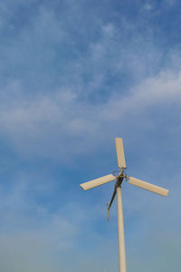 Low angle view of wind turbine against sky