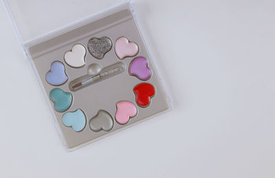 High angle view of multi colored heart shape on white background