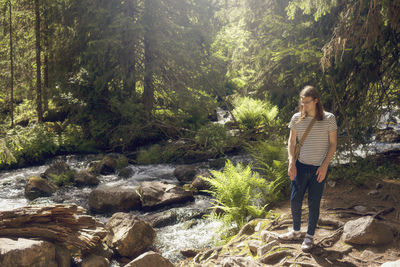 Young man at forest river