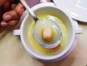 Cropped hand holding food on table