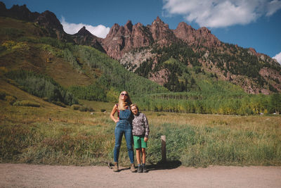 Rear view of two women on mountain against sky