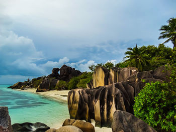 Panoramic shot of rocks by sea against sky