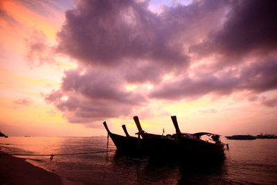 Silhouette boat in sea against sky during sunset