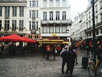 People in city against sky