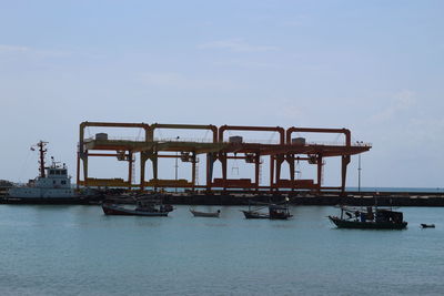 Silhouette pier on sea against sky