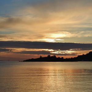 Scenic view of sea against sky at sunset