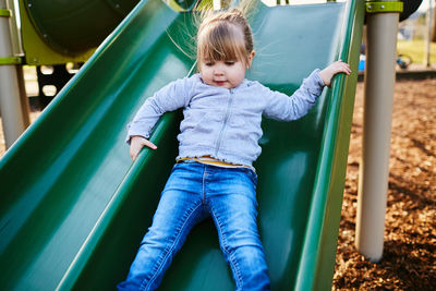 Girl playing on slide at park