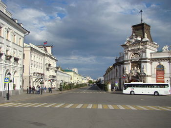 City street by buildings against sky