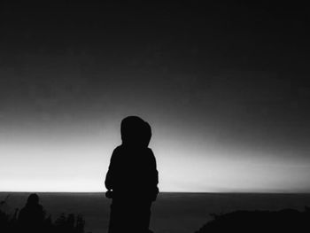 Rear view of silhouette man and woman looking at view