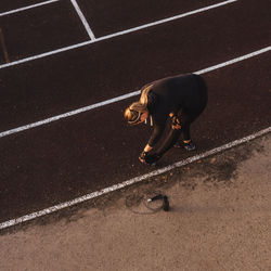 Full length of woman exercising in stadium