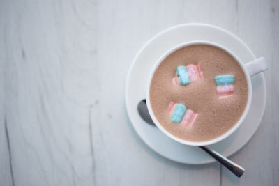 A cup of cocoa with marshmallows in a cafe on a wooden table