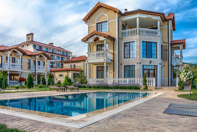 House by pool against sky