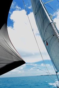 Low angle view of sailboat on sea against sky