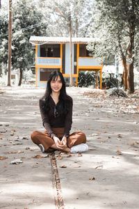 Portrait of smiling woman sitting outdoors
