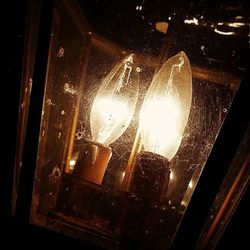 Close-up of light bulb at night