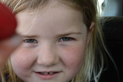 Close up blonde little girl captivating face. 