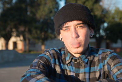 Portrait of young blue eyed  man smoking