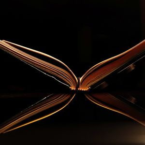 Close-up of illuminated lighting equipment against black background