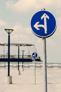 Close-up of road sign against blue sky