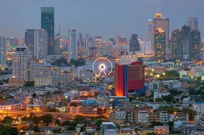 High angle view of city lit up at night