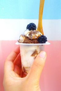 Close-up of hand holding ice cream