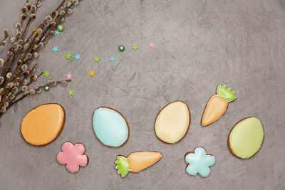 Delicious cookies with colorful glaze on grey concrete background.