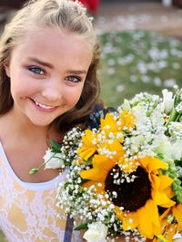 Portrait of smiling woman with flower bouquet
