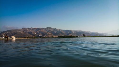 Scenic view of sea against clear blue sky