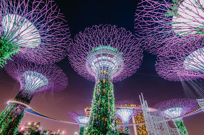 Low angle view of illuminated ferris wheel at night