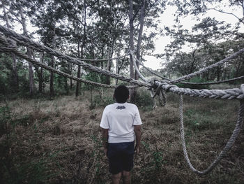 Rear view of man looking at forest