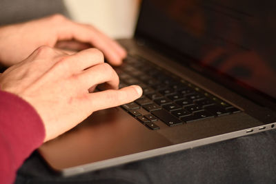 Hands typing on the keyboard of a notebook