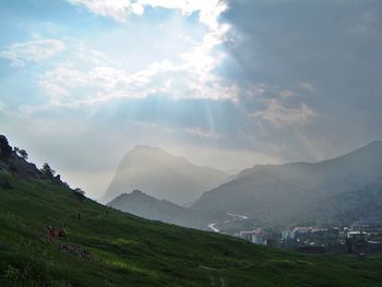 Scenic view of mountains against cloudy sky