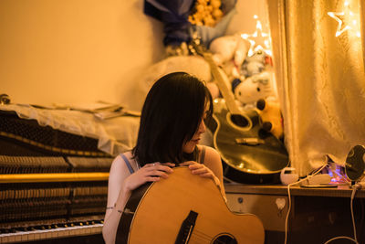 Rear view of woman looking at illuminated stage